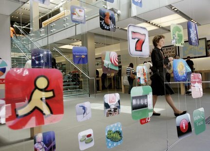 A woman walks past icons for Apple applications at the company's retail store in San Francisco, California April 22, 2009. REUTERS/Robert Ga A woman walks past icons for Apple applications at the company's retail store in San Francisco, California April 22, 2009. REUTERS/Robert Ga