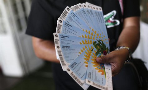 A Colombian fan displays his FIFA 2014 World Cup tickets for the match between Colombia and Greece, in Rio de Janeiro April 18, 2014. REUTER