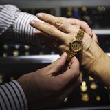 Store manager Jared Minsky talks to a potential customer about gold watches inside the Gold Standard jewellery store in New York, April 15, Store manager Jared Minsky talks to a potential customer about gold watches inside the Gold Standard jewellery store in New York, April 15,