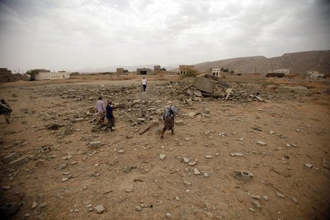 Tribesmen stand on the rubble of a building destroyed by a U.S. drone air strike, that targeted suspected al Qaeda militants in Azan of the Tribesmen stand on the rubble of a building destroyed by a U.S. drone air strike, that targeted suspected al Qaeda militants in Azan of the