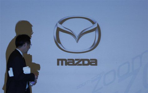 A man walks past a Mazda Motor Corp logo projected on a screen at a news conference in Tokyo April 27, 2010. REUTERS/Yuriko Nakao A man walks past a Mazda Motor Corp logo projected on a screen at a news conference in Tokyo April 27, 2010. REUTERS/Yuriko Nakao