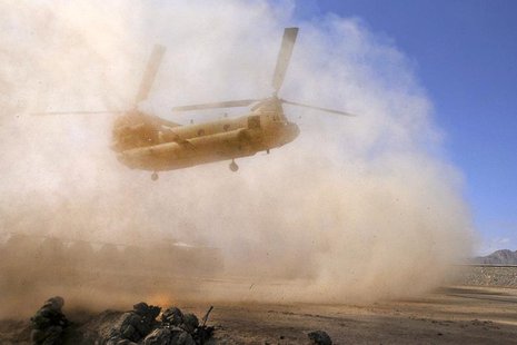 U.S. Army soldiers with the 10th Mountain Division prepare to board a CH-47 Chinook troop transport helicopter after completing their missio U.S. Army soldiers with the 10th Mountain Division prepare to board a CH-47 Chinook troop transport helicopter after completing their missio