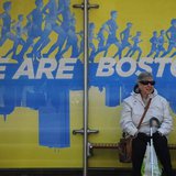 A woman waits at a bus stop near the finish line of the Boston Marathon in Boston, Massachusetts on April 17th, 2014. (Reuters/Brian Snyder) A woman waits at a bus stop near the finish line of the Boston Marathon in Boston, Massachusetts on April 17th, 2014. (Reuters/Brian Snyder)