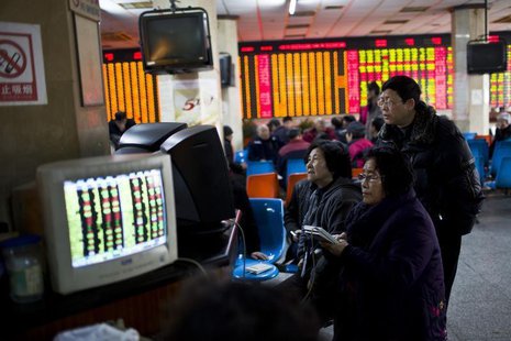 Investors look at computer screens showing stock information at a brokerage house in Shanghai, March 4, 2014. REUTERS/Aly Song Investors look at computer screens showing stock information at a brokerage house in Shanghai, March 4, 2014. REUTERS/Aly Song