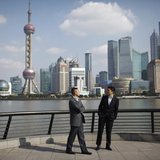 Businessmen walk on the Bund near the Huangpu River in front of the financial district of Pudong in Shanghai November 21, 2011. REUTERS/Aly Businessmen walk on the Bund near the Huangpu River in front of the financial district of Pudong in Shanghai November 21, 2011. REUTERS/Aly