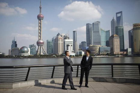 Businessmen walk on the Bund near the Huangpu River in front of the financial district of Pudong in Shanghai November 21, 2011. REUTERS/Aly Businessmen walk on the Bund near the Huangpu River in front of the financial district of Pudong in Shanghai November 21, 2011. REUTERS/Aly