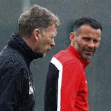 Manchester United's manager David Moyes (L) walks past Ryan Giggs during a training session at the club's Carrington training complex in Man Manchester United's manager David Moyes (L) walks past Ryan Giggs during a training session at the club's Carrington training complex in Man