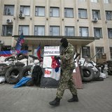 A pro-Russian armed man walks near a barricade outside a regional government building seized by them in Kramatorsk, eastern Ukraine April 22 A pro-Russian armed man walks near a barricade outside a regional government building seized by them in Kramatorsk, eastern Ukraine April 22