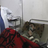 A man, affected by what activists say was a gas attack, breathes through an oxygen mask inside a field hospital in Kfar Zeita village in the A man, affected by what activists say was a gas attack, breathes through an oxygen mask inside a field hospital in Kfar Zeita village in the