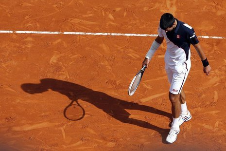 Novak Djokovic of Serbia reacts after missing a point during his match against Roger Federer of Switzerland during their semi-final match at Novak Djokovic of Serbia reacts after missing a point during his match against Roger Federer of Switzerland during their semi-final match at
