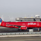 A JetBlue Airbus A320-200 plane with a New York Fire Department logo painted on its side stands on the tarmac of the John F. Kennedy Interna A JetBlue Airbus A320-200 plane with a New York Fire Department logo painted on its side stands on the tarmac of the John F. Kennedy Interna