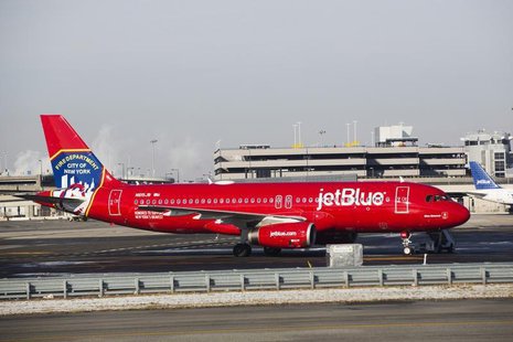 A JetBlue Airbus A320-200 plane with a New York Fire Department logo painted on its side stands on the tarmac of the John F. Kennedy Interna A JetBlue Airbus A320-200 plane with a New York Fire Department logo painted on its side stands on the tarmac of the John F. Kennedy Interna