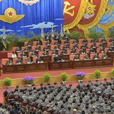 North Korean leader Kim Jong Un (front row on stage, 5th L) speaks while presiding over the first meeting of the airpersons of the Korean Pe North Korean leader Kim Jong Un (front row on stage, 5th L) speaks while presiding over the first meeting of the airpersons of the Korean Pe