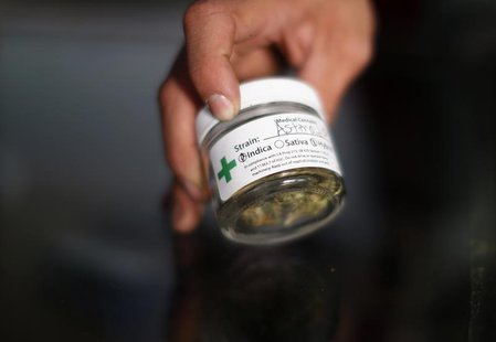A volunteer displays cannabis buds at the La Brea Collective medical marijuana dispensary in Los Angeles, California, March 18, 2014. REUTER A volunteer displays cannabis buds at the La Brea Collective medical marijuana dispensary in Los Angeles, California, March 18, 2014. REUTER