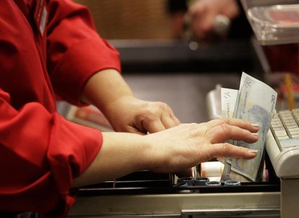 A cashier holds euro banknotes in Riga January 1, 2014. REUTERS Ints Kalnins A cashier holds euro banknotes in Riga January 1, 2014. REUTERS Ints Kalnins