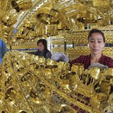 Employees work on the production line of a wine bottle cap factory in Ganyu county, Jiangsu province May 6, 2013. REUTERS/China Daily Employees work on the production line of a wine bottle cap factory in Ganyu county, Jiangsu province May 6, 2013. REUTERS/China Daily