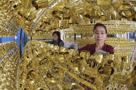 Employees work on the production line of a wine bottle cap factory in Ganyu county, Jiangsu province May 6, 2013. REUTERS/China Daily Employees work on the production line of a wine bottle cap factory in Ganyu county, Jiangsu province May 6, 2013. REUTERS/China Daily