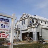 A new home is being built next to a home with a for sale sign on a street in Vienna, on the morning the National Association of Realtors iss A new home is being built next to a home with a for sale sign on a street in Vienna, on the morning the National Association of Realtors iss