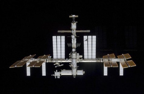 Backdropped by the blackness of space, the International Space Station is seen in this image taken by a crew member aboard the Space Shuttle Backdropped by the blackness of space, the International Space Station is seen in this image taken by a crew member aboard the Space Shuttle