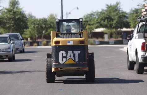 A worker drives a Caterpillar tractor near a construction site in Gilbert, Arizona October 20, 2009.REUTERS/Joshua Lott A worker drives a Caterpillar tractor near a construction site in Gilbert, Arizona October 20, 2009.REUTERS/Joshua Lott