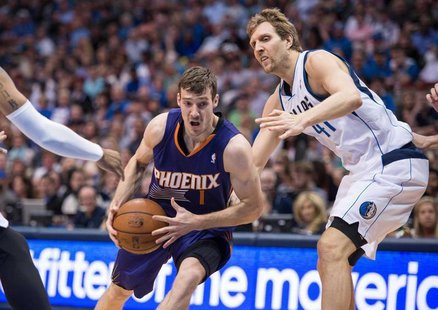 Apr 12, 2014; Dallas, TX, USA; Phoenix Suns guard Goran Dragic (1) drives to the basket past Dallas Mavericks forward Shawn Marion (0) and f Apr 12, 2014; Dallas, TX, USA; Phoenix Suns guard Goran Dragic (1) drives to the basket past Dallas Mavericks forward Shawn Marion (0) and f