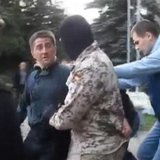 Horlivka city deputy Volodymyr Rybak (L) is manhandled by several men, among them a masked man in camouflage, outside a city hall building i Horlivka city deputy Volodymyr Rybak (L) is manhandled by several men, among them a masked man in camouflage, outside a city hall building i