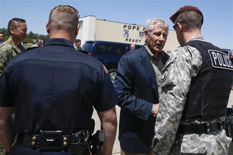U.S. Defense Secretary Chuck Hagel (2nd R) hands out commander coins before leaving Pope Army Airfield in Fort Bragg, North Carolina April 2 U.S. Defense Secretary Chuck Hagel (2nd R) hands out commander coins before leaving Pope Army Airfield in Fort Bragg, North Carolina April 2