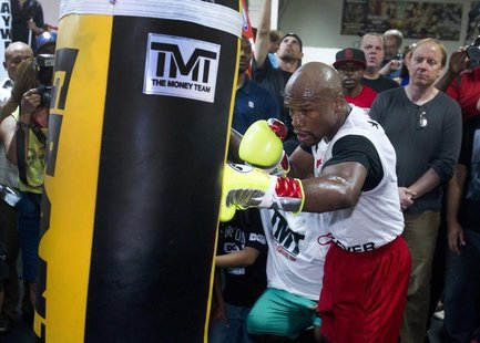 World Boxing Council (WBC) welterweight champion Floyd Mayweather Jr. of the U.S. hits a punching bag during a media workout at the Mayweath World Boxing Council (WBC) welterweight champion Floyd Mayweather Jr. of the U.S. hits a punching bag during a media workout at the Mayweath