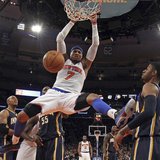 New York Knicks forward Carmelo Anthony slam dunks the ball in front of Indiana Pacers forward Paul George (R) in the second half of their N New York Knicks forward Carmelo Anthony slam dunks the ball in front of Indiana Pacers forward Paul George (R) in the second half of their N