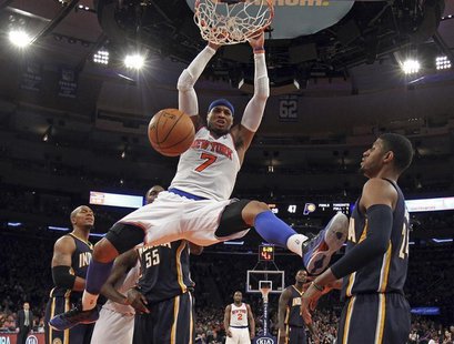 New York Knicks forward Carmelo Anthony slam dunks the ball in front of Indiana Pacers forward Paul George (R) in the second half of their N New York Knicks forward Carmelo Anthony slam dunks the ball in front of Indiana Pacers forward Paul George (R) in the second half of their N