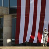 A soldier stands outside the venue for a memorial service on Sadowski Field at III Corps Headquarters for the victims of last Wednesday's sh A soldier stands outside the venue for a memorial service on Sadowski Field at III Corps Headquarters for the victims of last Wednesday's sh