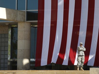 A soldier stands outside the venue for a memorial service on Sadowski Field at III Corps Headquarters for the victims of last Wednesday's sh A soldier stands outside the venue for a memorial service on Sadowski Field at III Corps Headquarters for the victims of last Wednesday's sh