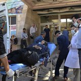A woman affected by what activists say was a gas attack on the town of Telminnes is transferred to Bab al-Hawa hospital, which is close to t A woman affected by what activists say was a gas attack on the town of Telminnes is transferred to Bab al-Hawa hospital, which is close to t