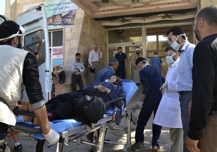 A woman affected by what activists say was a gas attack on the town of Telminnes is transferred to Bab al-Hawa hospital, which is close to t A woman affected by what activists say was a gas attack on the town of Telminnes is transferred to Bab al-Hawa hospital, which is close to t