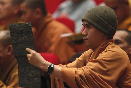 A Buddhist monk films, with an iPad, the closing ceremony of the seventh congress of Vietnam's Buddhist Sangha Association in Hanoi November A Buddhist monk films, with an iPad, the closing ceremony of the seventh congress of Vietnam's Buddhist Sangha Association in Hanoi November