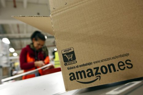 A worker packs a box at Amazon's logistics centre in Graben near Augsburg December 16, 2013. REUTERS/Michaela Rehle A worker packs a box at Amazon's logistics centre in Graben near Augsburg December 16, 2013. REUTERS/Michaela Rehle