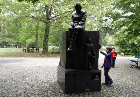 Children play next to the memorial statue of Formula One Brazilian driver Ayrton Senna in the park inside the race track at Imola April 22, Children play next to the memorial statue of Formula One Brazilian driver Ayrton Senna in the park inside the race track at Imola April 22,