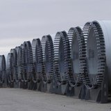 The base of several wind turbine blades are seen outside TPI Composites in Newton, Iowa December 22, 2011. REUTERS/Joshua Lott