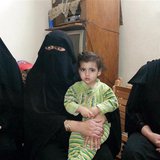 The wife (L) and other family members of Fahmy Abdel Raouf, who was killed with his 13-year-old son in a gun battle with security forces, si The wife (L) and other family members of Fahmy Abdel Raouf, who was killed with his 13-year-old son in a gun battle with security forces, si