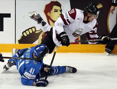 Latvia's Ralfs Freibergs (top) trips over Finland's Antti Pihlstrom during their 2013 IIHF Ice Hockey World Championship preliminary round m Latvia's Ralfs Freibergs (top) trips over Finland's Antti Pihlstrom during their 2013 IIHF Ice Hockey World Championship preliminary round m