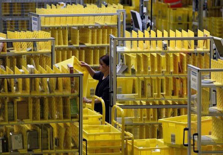 Worker collects items at Amazon's logistics centre in Graben near Augsburg December 16, 2013. REUTERS/Michaela Rehle Worker collects items at Amazon's logistics centre in Graben near Augsburg December 16, 2013. REUTERS/Michaela Rehle