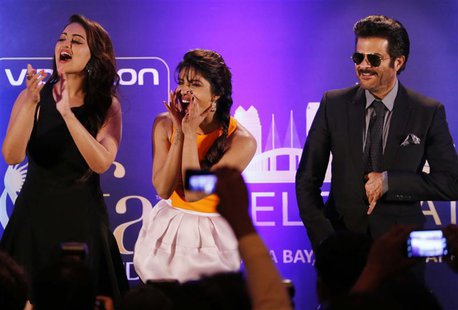 Bollywood Actress Priyanka Chopra (C) and Actress Sonakshi Sinha and Anil Kapoor (R) entertain the crowd ahead of the 15th International Ind Bollywood Actress Priyanka Chopra (C) and Actress Sonakshi Sinha and Anil Kapoor (R) entertain the crowd ahead of the 15th International Ind