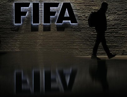 A man is silhouetted as he makes his way past the main entrance of FIFA headquarters, the Home of FIFA, in Zurich October 20, 2010. REUTERS/ A man is silhouetted as he makes his way past the main entrance of FIFA headquarters, the Home of FIFA, in Zurich October 20, 2010. REUTERS/