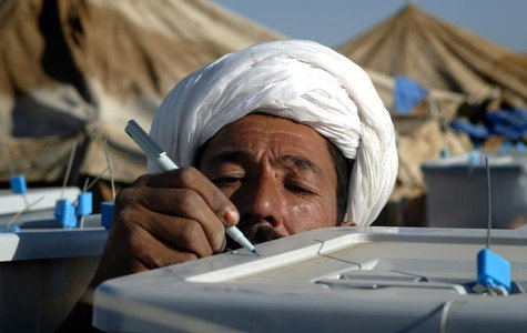 An Afghan man working as inspector for political party marks ballot box at election counting centre in Herat. REUTERS/Caren Firouz An Afghan man working as inspector for political party marks ballot box at election counting centre in Herat. REUTERS/Caren Firouz