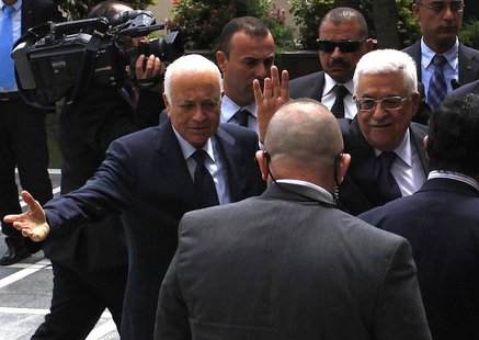 Arab League Chief Nabil al-Arabi (L) greets Palestinian President Mahmoud Abbas, who waves to the media, before attending an Arab Foreign Mi Arab League Chief Nabil al-Arabi (L) greets Palestinian President Mahmoud Abbas, who waves to the media, before attending an Arab Foreign Mi