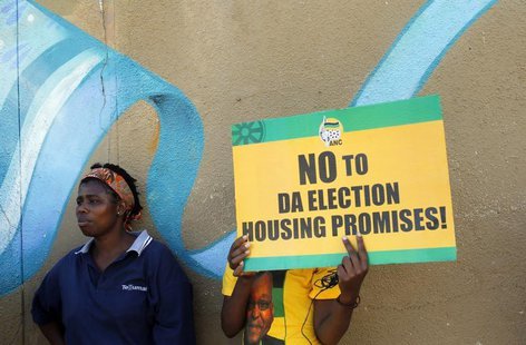 Supporters of President Jacob Zuma's ruling African National Congress (ANC) await the start of a march on the headquarters of the opposition Supporters of President Jacob Zuma's ruling African National Congress (ANC) await the start of a march on the headquarters of the opposition
