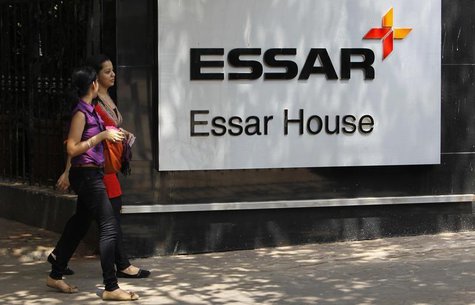 Employees walk past an Essar Group logo outside their headquarters in Mumbai May 20, 2013. REUTERS/Vivek Prakash Employees walk past an Essar Group logo outside their headquarters in Mumbai May 20, 2013. REUTERS/Vivek Prakash