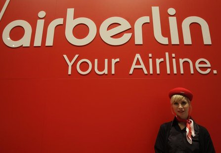 A woman stands behind the exhibition stand of Air Berlin at the ITB tourism fair in Berlin, March 11, 2009. REUTERS/Tobias Schwarz A woman stands behind the exhibition stand of Air Berlin at the ITB tourism fair in Berlin, March 11, 2009. REUTERS/Tobias Schwarz