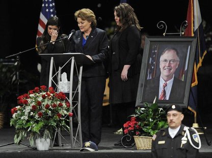 Lisa Clements, the widow of chief executive of the Colorado Department of Corrections, Tom Clements, is supported by her daughters Sara (L) Lisa Clements, the widow of chief executive of the Colorado Department of Corrections, Tom Clements, is supported by her daughters Sara (L)