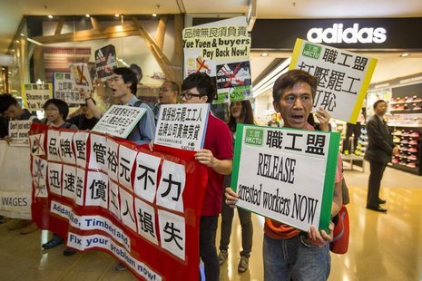 Protesters from labour organizations shout slogans in support of the strike by workers at a Yue Yuen Industrial Holdings Ltd shoe factory co Protesters from labour organizations shout slogans in support of the strike by workers at a Yue Yuen Industrial Holdings Ltd shoe factory co